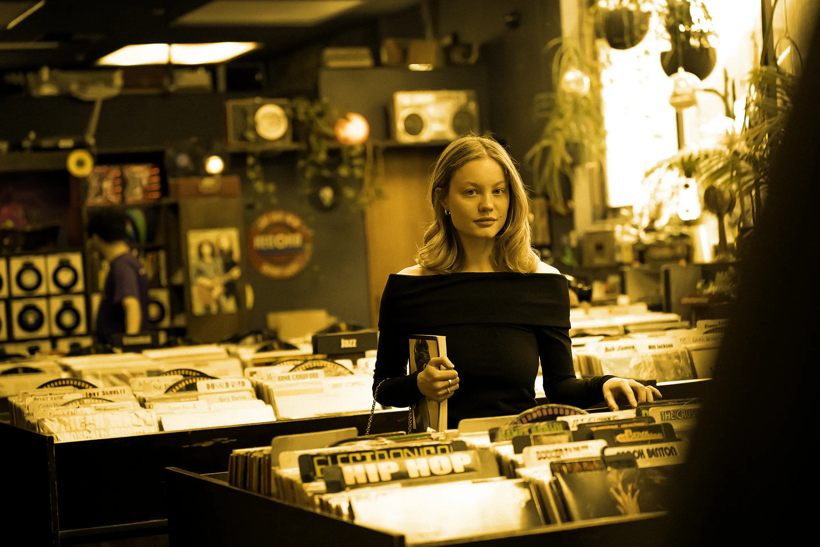 A woman in a record shop, among the crates