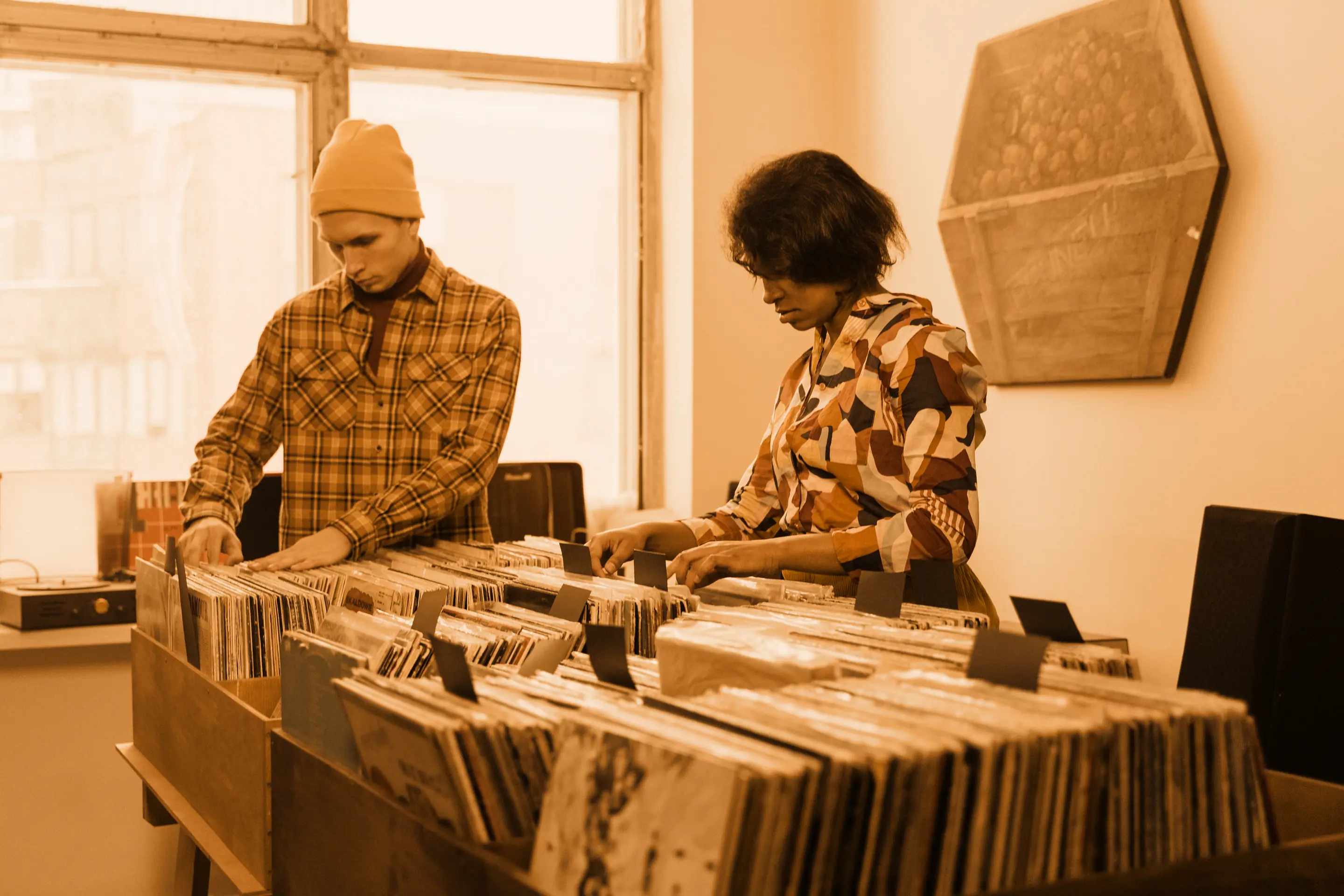 Two people browsing the crates in a record shop