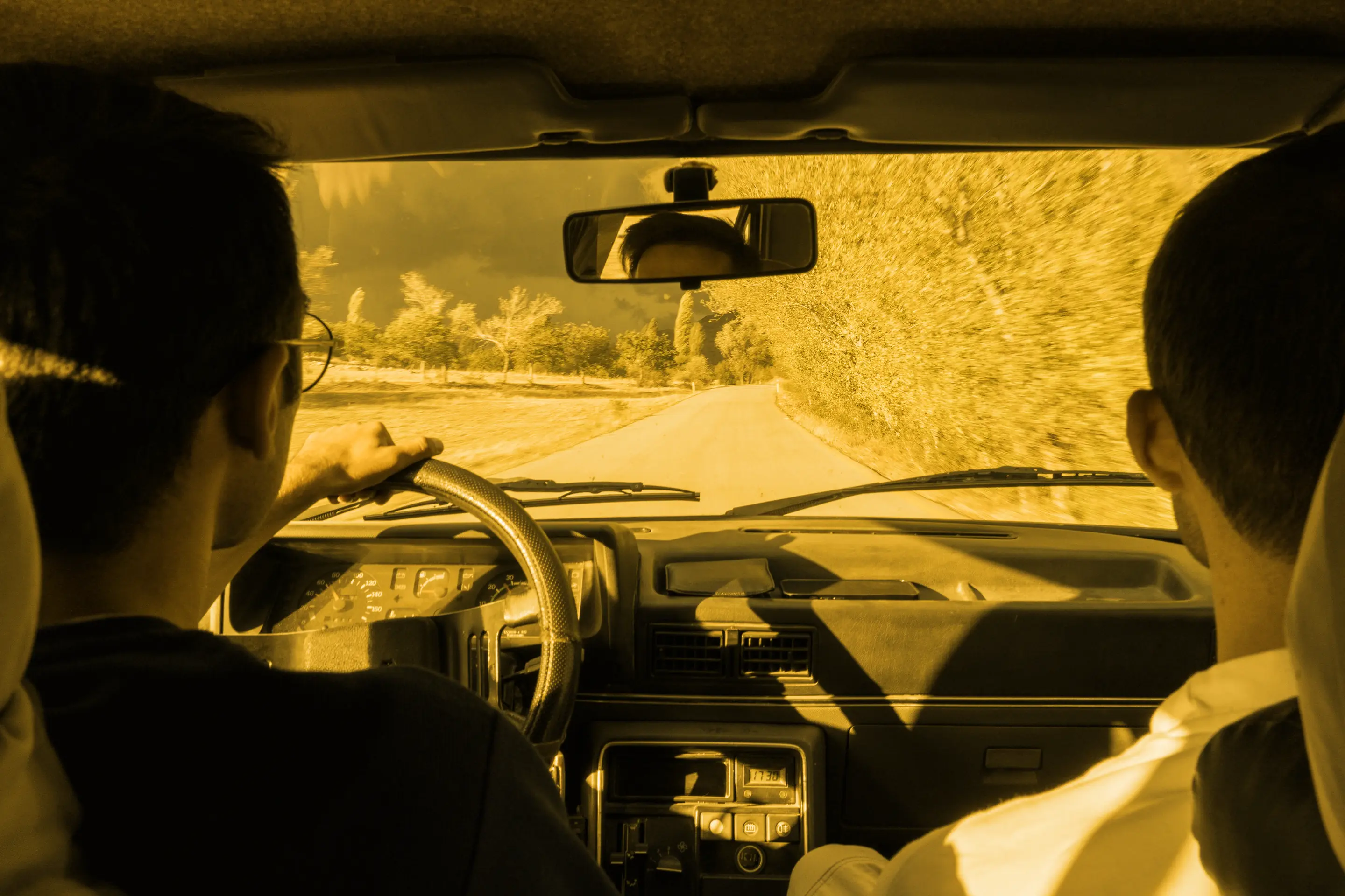 Two friends driving down a country road